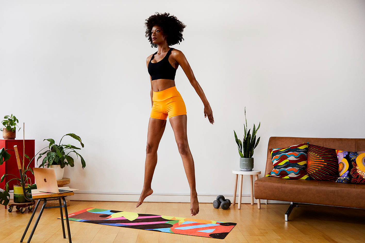 A woman practicing yoga on a Flowstate yoga mat