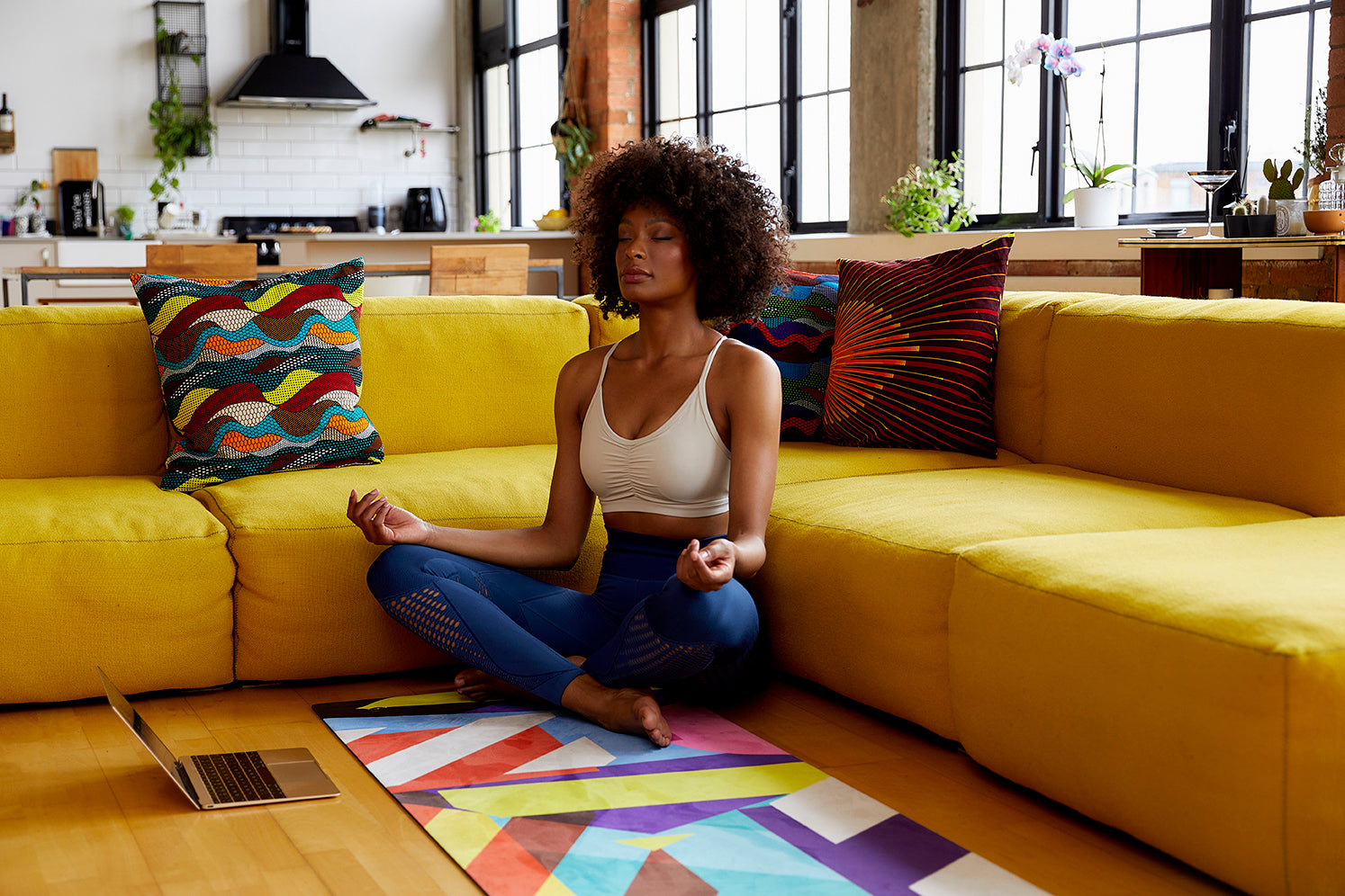 A woman practicing yoga on a Flowstate yoga mat