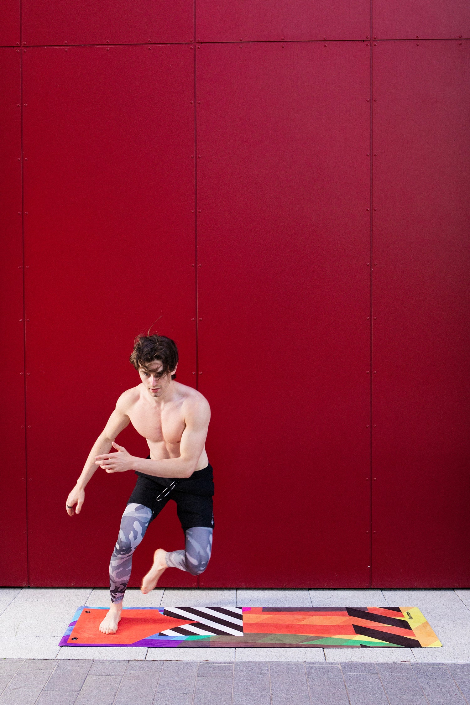 A man practicing yoga on a Flowstate yoga mat