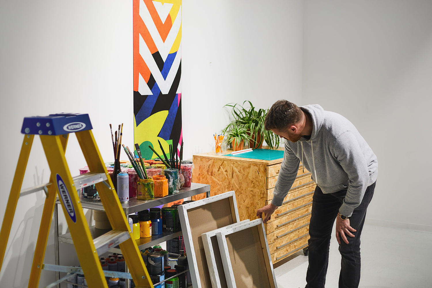 Maser in his studio with a Flowstate yoga mat handing on the wall nearby